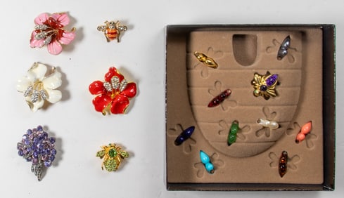 Seven Joan Rivers costume jewelry brooches, including an interchangeable bee brooch