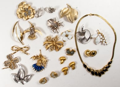 Seventeen Trifari costume jewelry brooches with three pairs of Trifari earrings and a Trifari