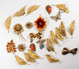 Twenty-two pieces of Coro costume jewelry brooches with a pair of Coro earrings