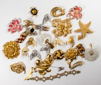 Thirty-two pieces of Monet costume jewelry comprising (30) brooches, (1) bracelet and (1) pair of