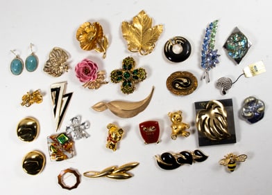 Sixteen Trifari costume jewelry brooches, (2) pairs of Trifari earrings with eight additional pieces