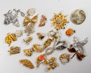 Twenty-one costume jewelry brooches, comprising BSK, Swarovski, Hunter, Kramer of NY, Jeanne and
