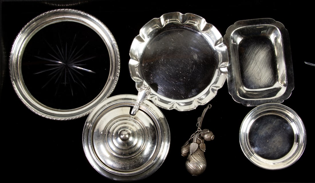 Seven pieces of sterling table articles: Seven pieces of sterling table articles, comprising (5) nut dishes; (1) covered condiment dish with serving spoon, (1) sterling and cut glass wine coaster; with (1) decorative fruit form miniature. 7.