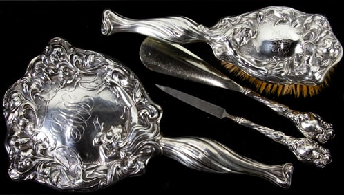An Art Nouveau monogramed sterling four-piece dresser set