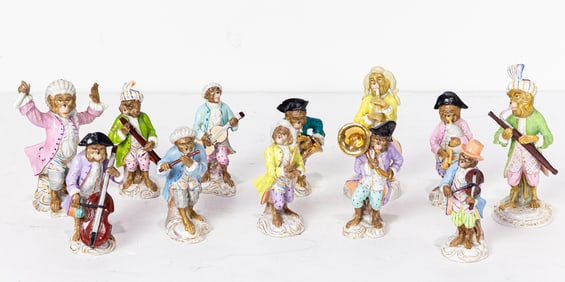 A group of twelve Meissen style porcelain monkey band figures