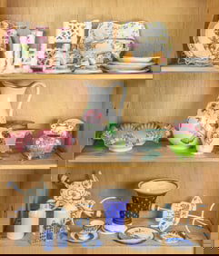 A collection of collection of ceramic and tole table articles