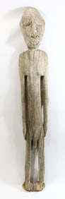 A tall standing carved wood male figure, Papua New Guinea