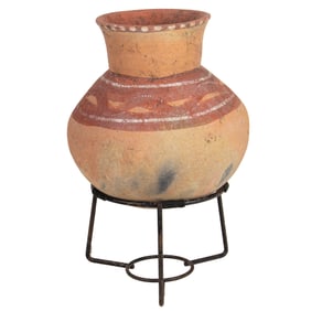 A Native American vessel on iron stand