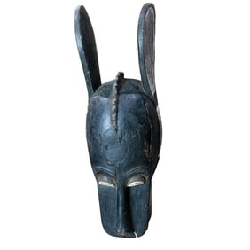 A Baule polychrome wood mask with large ears, Ivory Coast