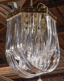 A modern six-light chandelier of cascading lucite ribbons form
