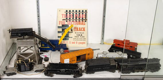 A twelve piece collection of mainly Lionel O-gauge model trains and accessories