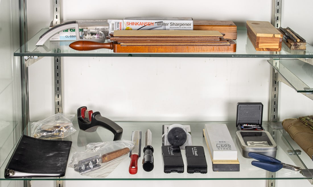 Two shelves of knife sharpening tools and whet stones, including CRKT Slide Sharp knife sharpening (1 of 1)