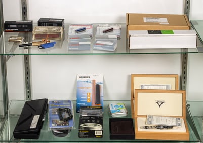 Two shelves of knives and camping accessories