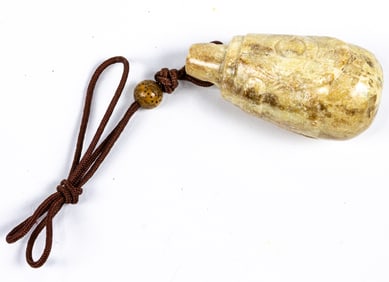 A Chinese chicken bone jade tear drop pendant