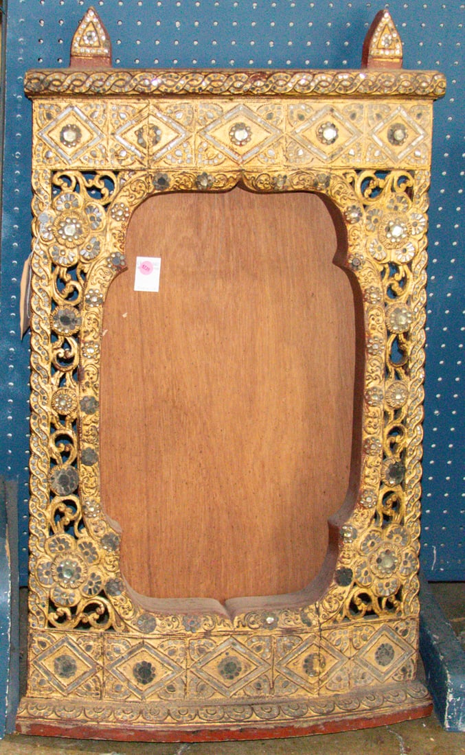 An Indian gilt wood frame: An Indian gilt wood frame. 36.5"h x 22"w.