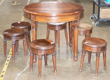 A Chinese seven-piece rosewood dining table and stools