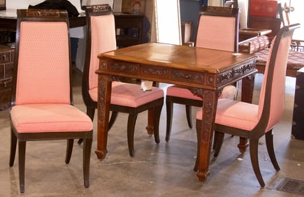 A Chinese rosewood mahjong table and four cushioned chairs