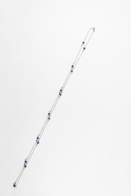 A sapphire, white topaz, and 18k white gold necklace