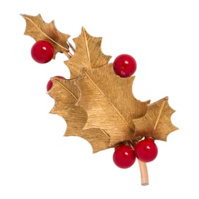 A Krementz holly gold-tone brooch