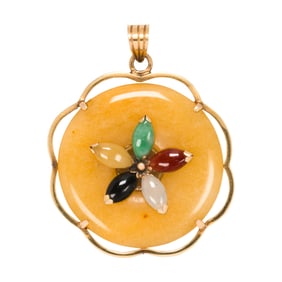 A jade and 14k gold pendant
