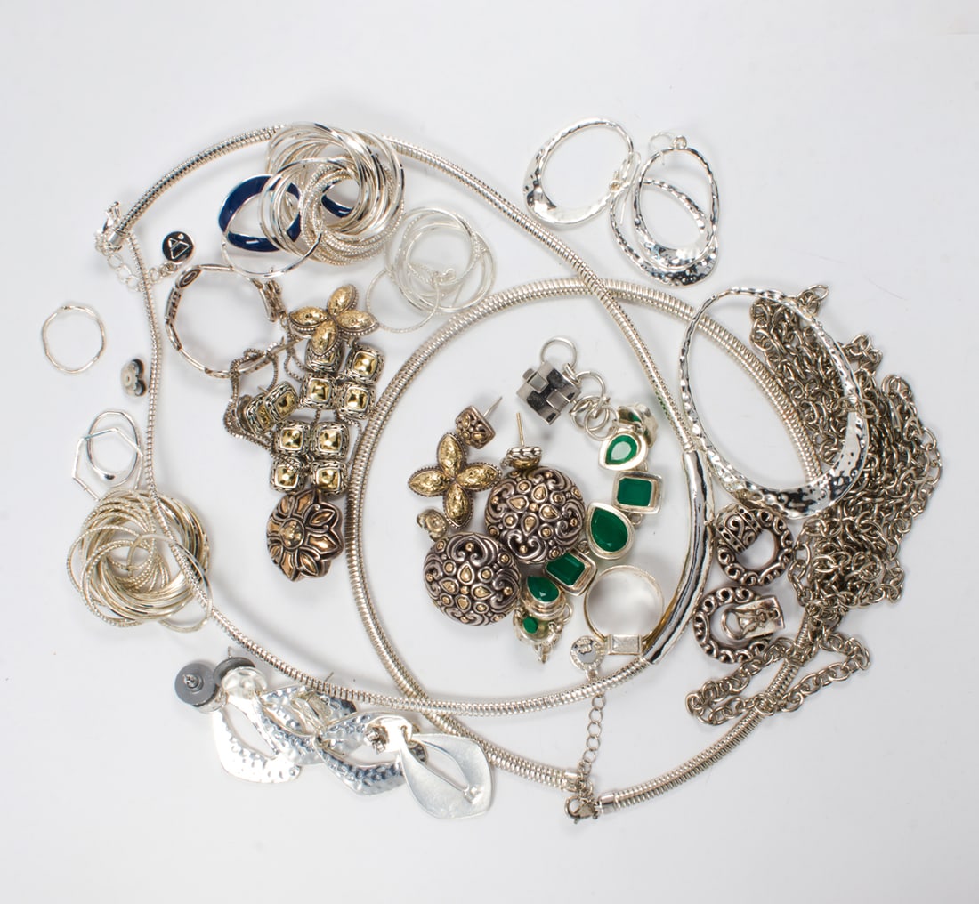 A group of silver tone costume jewelry: A group of silver tone costume jewelry Comprising an assortment of silver costume jewelry of varying styles; gross weight: 282.65 grams
