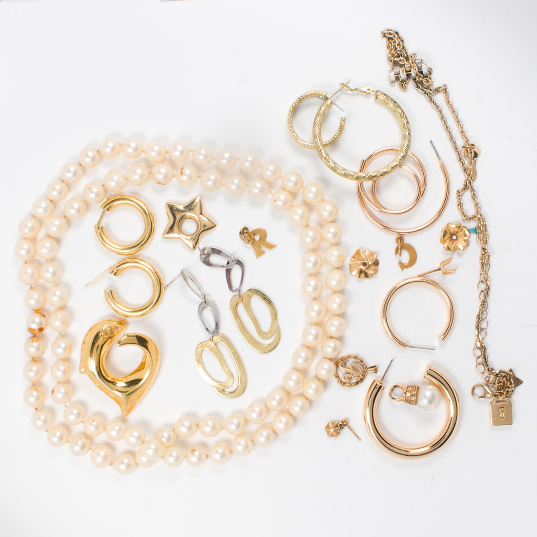 A group of gold tone costume jewelry: A group of gold tone costume jewelry Comprising an assortment of gold-toned costume jewelry of varying styles; gross weight: 142.60 grams