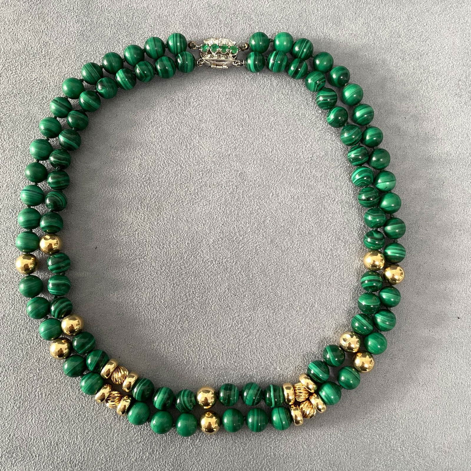 Two Strand Malachite and 14K Yellow Gold Bead Necklace with Diamond Emerald Clasp: Two strand malachite and 14k yellow gold bead necklace with white gold diamond emerald clasp. Necklace length: 16 1/2 in; bead diameter approximately 7mm; gross weight 87.2 gram. NOTE: THIS ITEM IS IN