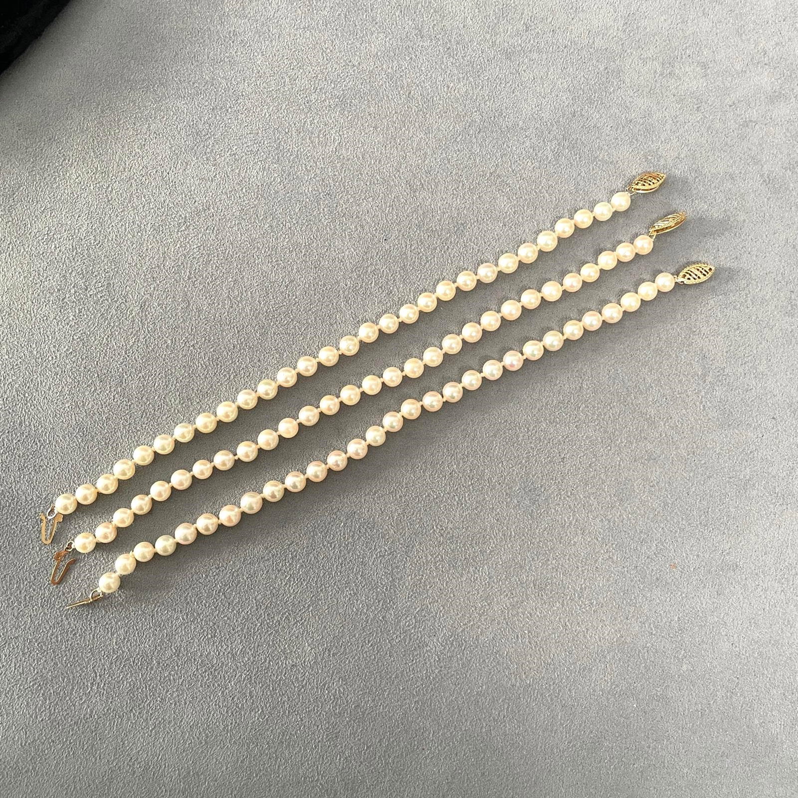 Three Single Strands Japanese Salt Water Cultured Pearl and 14K Yellow Gold Bracelet: ( lot of 3) Three Single Strands Japanese Salt Water Culture Pearl And 14K Yellow Gold Bracelet. Bracelet Length: 7 in; pearl diameter approximately 5-5.5mm; gross weight 19.5 grams. NOTE: THIS ITEM I