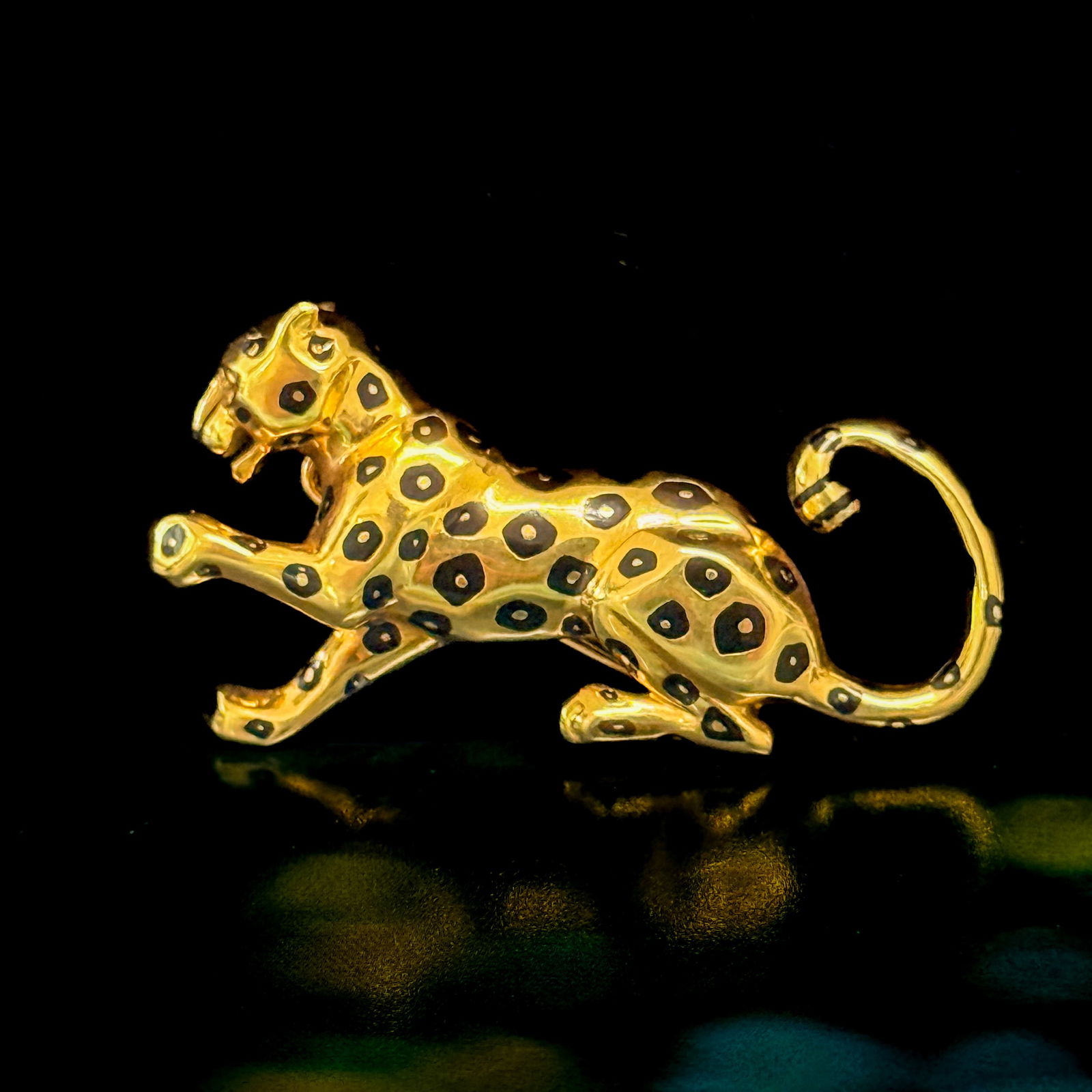 Cartier Black Enamel and 18K Yellow Gold Panthere Brooch: Cartier 18k yellow gold panthere black enamel spotted brooch. Brooch measures approximately 1 7/8 x 1 inches; signed "Cartier 750 612051"; gross weight 14.8 gram.NOTE: THIS ITEM IS IN NEW YO