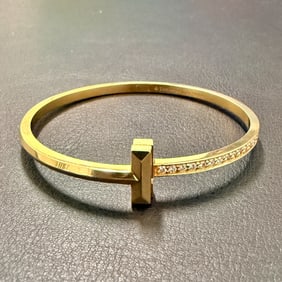 Tiffany & Co., Diamond and 18K Yellow Gold 'T' Wire Bangle