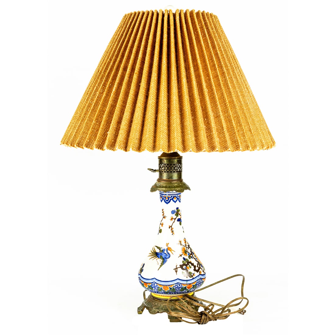 A French faience brass mounted oil lamp, Senator Feinstein Estate: A French faience brass mounted oil lamp, now fitted for electricity, early 20th century, 14.5"h (excluding electrical fittings). Provenance: The Estate of Senator Dianne Feinstein (1933-2023)