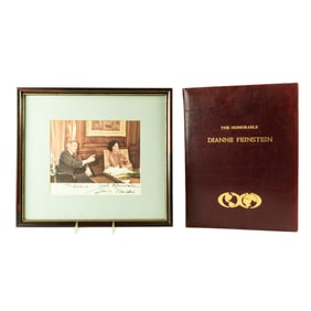A signed photograph of Senator Dianne Feinstein and Walter Mondale and a gold embossed leather folio
