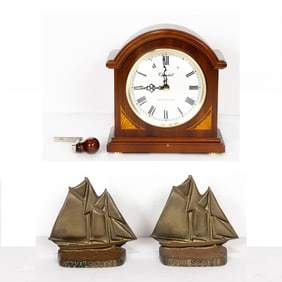 A Churchill mantel clock and a pair of brass bookends, Senator Feinstein Estate
