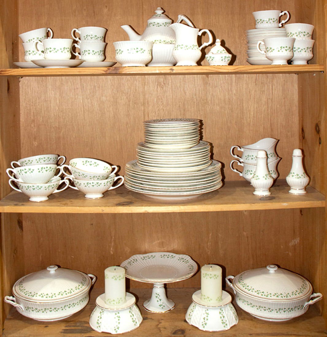 A Royal Tara porcelain dinner service, Senator Feinstein Estate: A Royal Tara porcelain dinner service in the Shamrock pattern, comprising (9) dinner plates; (9) salad plates; (11) bread & butter plates; (2) covered tureens; (1) pedestal cake plate; (2) candlestand