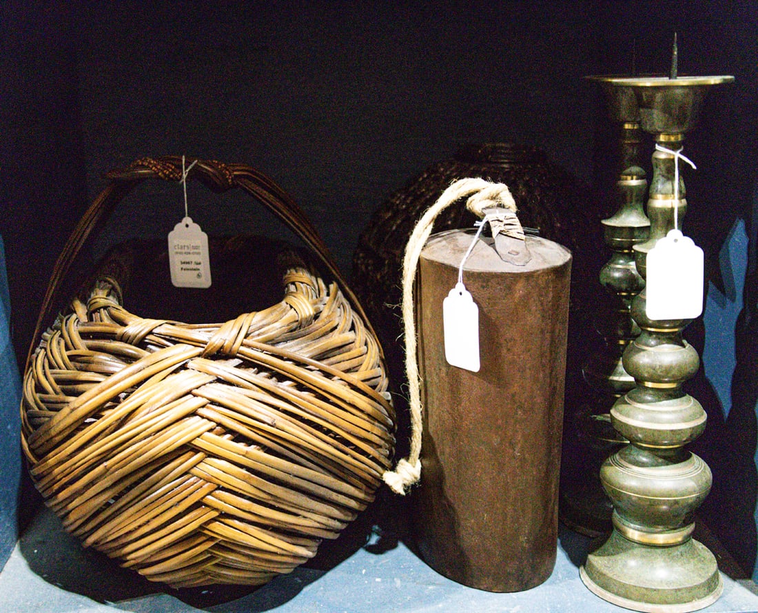 An assembled group, Senator Feinstein Estate: An assembled group, comprising pottery jar in woven frame, 14"h; pair of knopped pricket candlesticks, 18"h; large oval basket, 23"l and an iron gong or bell [5 total]. Provenance: The Estate of Senat