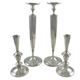 Two pairs of sterling weighted candlesticks including Gorham and Shreve and Co