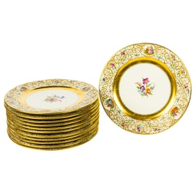 A set of twelve Lamm of Dresden raised gilt decorated service plates