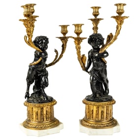 A pair of Louis XVI style gilt and patinated bronze three-light figural candelabra