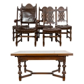 An oak extending dining table with eight dining chairs in the Louis XI style