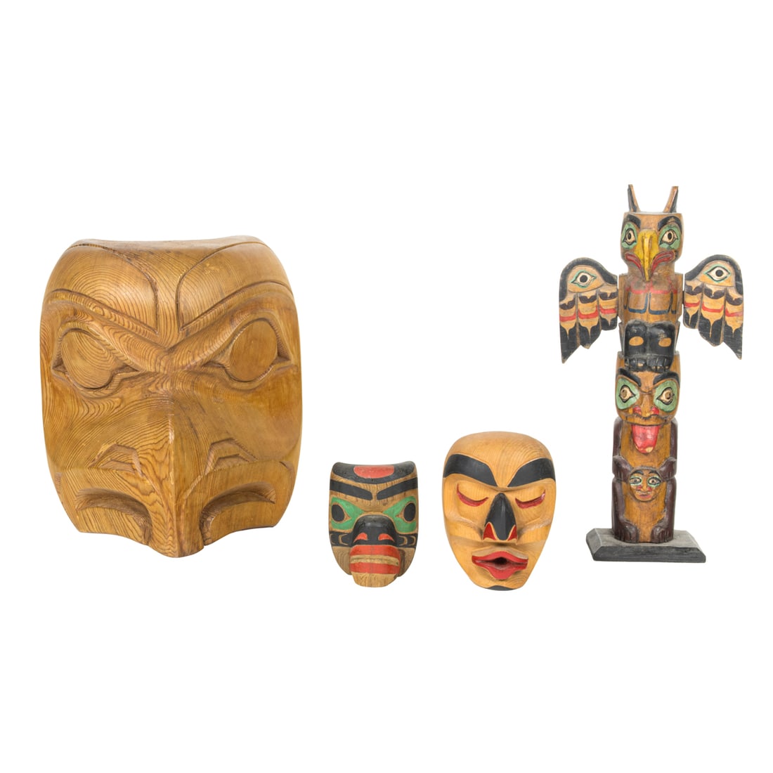 A Pacific-Northwest carved cedar group including masks and totem poles (1 of 7)