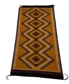 A Navajo Raised Outline rug by June Coleman 30" x 61" retains original tag
