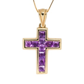 An amethyst and 14k gold cross pendant necklace