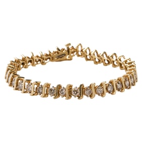 A diamond and 14k gold line bracelet