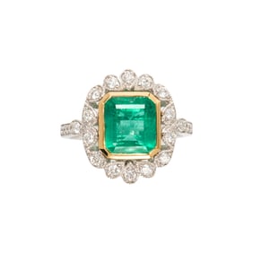 An emerald, diamond and 18k white gold ring