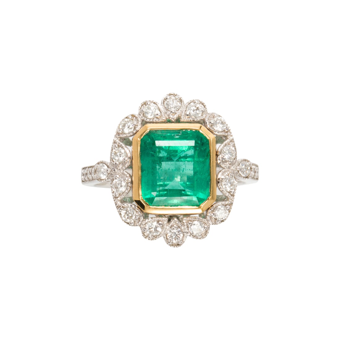 An emerald, diamond and 18k white gold ring: An emerald, diamond and 18k white gold ringcentering a rectangular-step cut emerald, weighing 3.20 carats, framed by round brilliant-cut diamonds; total diamond weight: 0.46 carats; 5.70 grams; size: