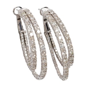 A pair of diamond and 14k white gold earrings