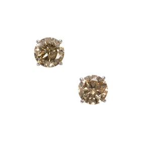 A pair of diamond and 14k white gold solitaire earrings
