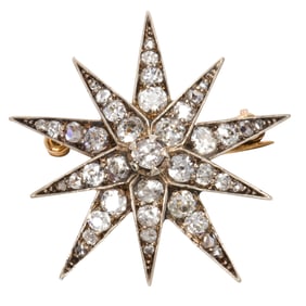A Victorian diamond and silver-topped 14k gold starburst brooch