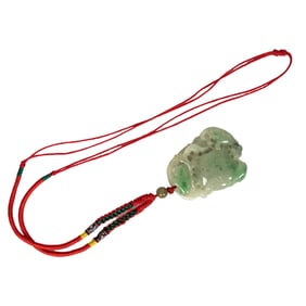 A Chinese green jadeite pendant
