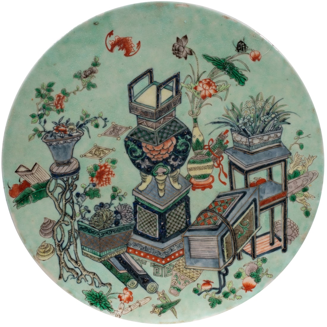 A Chinese famille verte porcelain plaque: A Chinese famille verte porcelain plaque. Depicting 'hundreds antique' motif, late Qing period, 11.375" across.